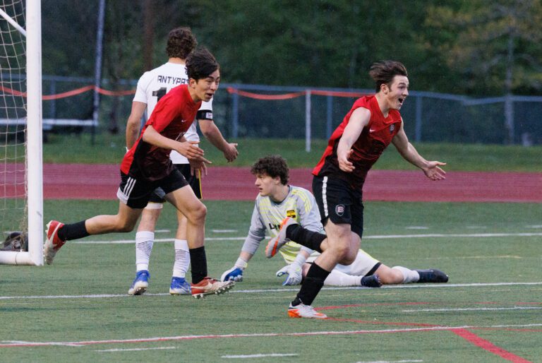 Bellingham's Aiden Buckingham, right, runs to his teammates.