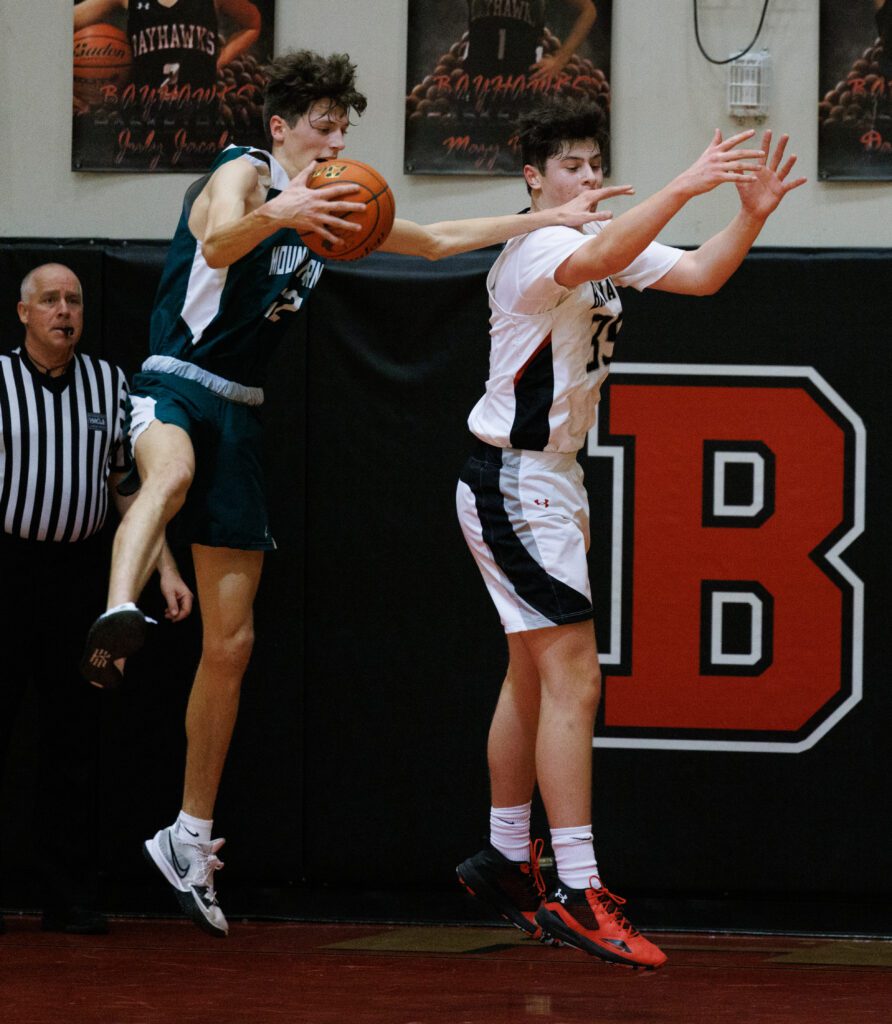 Mount Vernon's Lucas Rodio intercepts a pass intended for Bellingham's Henry Sheldrup next to him.