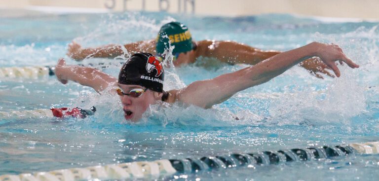 Bellingham's Kason Devaney leads Sehome’s Scotty Li as they breach the water for air mid-swim.