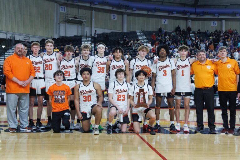 Blaine players and coaches pose with the third-place trophy.