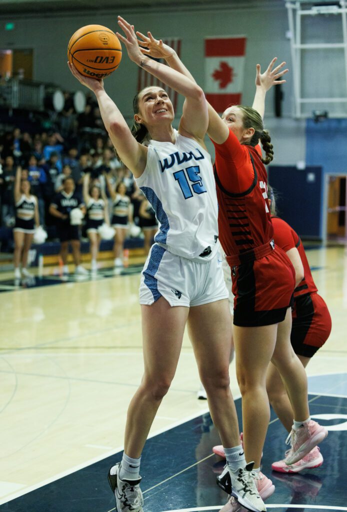 Western Washington University's Brooke Walling attempts to make a shot whilst under pressure from two defenders.