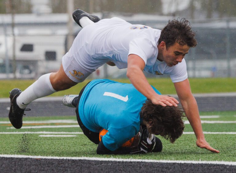 Ferndale’s Ruslan Yelfimov dives over Blaine goalkeeper Kael Evinger as they both fall to the ground.