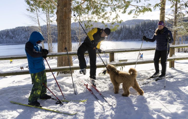 Willy Spaulding, center, son Liam and spouse Alex get ready to cross-country ski with their dog.