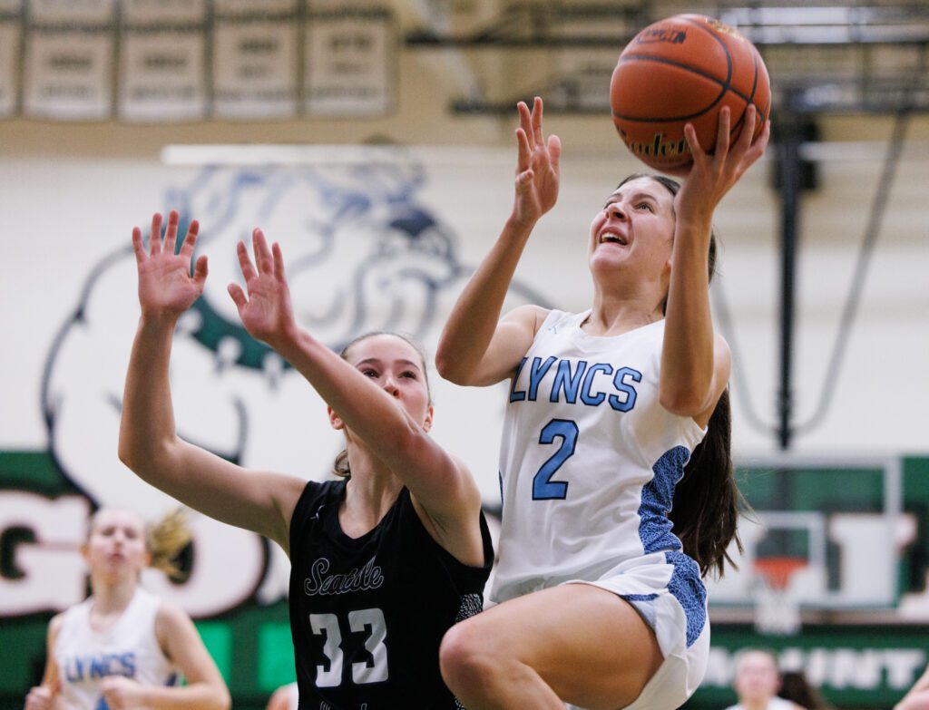 Lynden Christian's Demi Dykstra makes a basket as a defender reaches her too late.