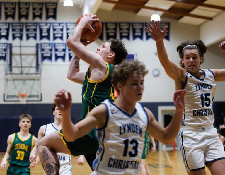 Sehome's Matt Storms blasts past the Lyncs' defense to put up the shot.