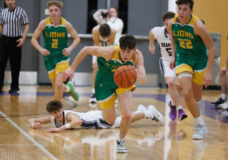 Lynden's Coston "Bubba" Parcher grabs the turnover by Anacortes' Davis Fogle, leaving behind a defender on the floor of the court.