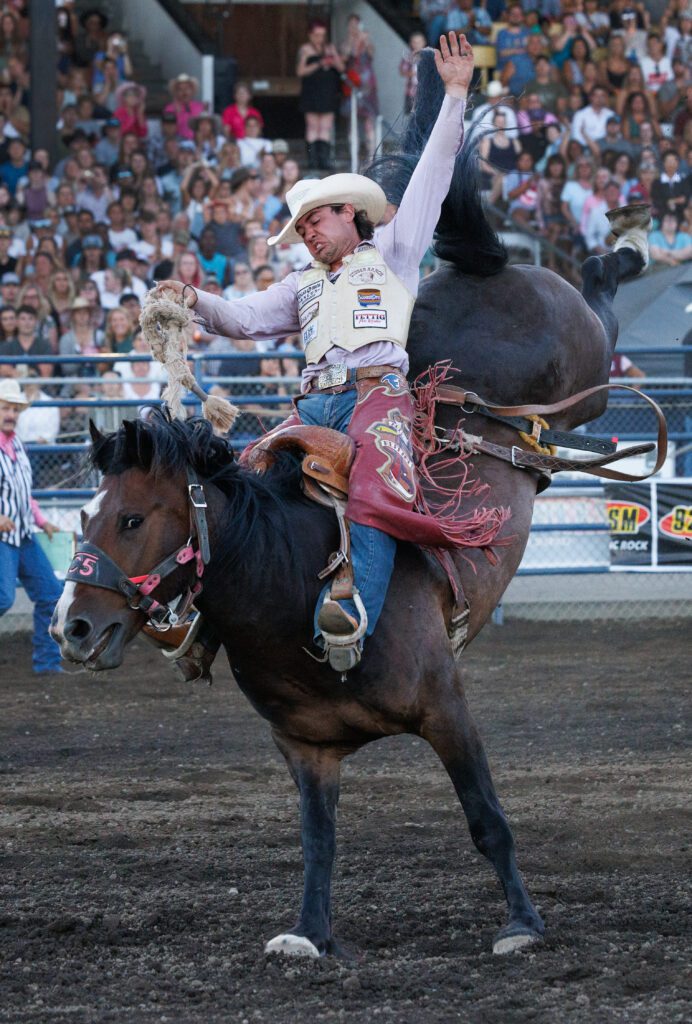 Cole Eshere of Faith, S.D., holds on to the bucking horse.