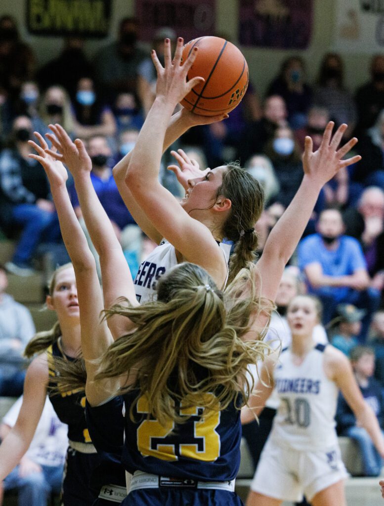 Nooksack Valley’s Devin Coppinger leaps over the defenders with the ball.