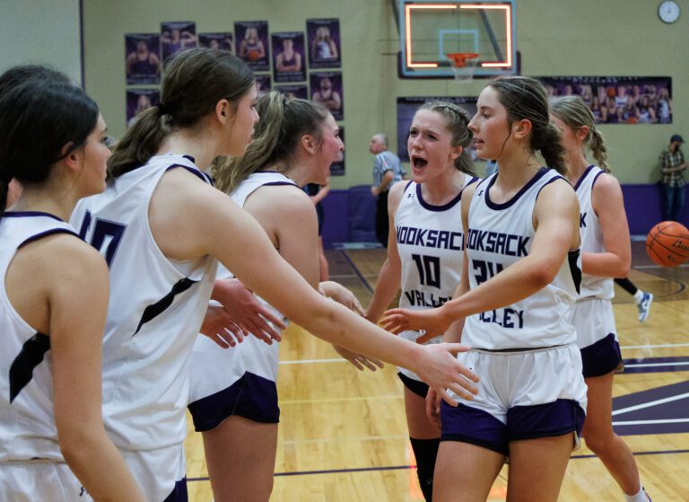 Nooksack Valley's Lainey Kimball (10) celebrates with teammates with low-fives.