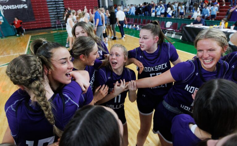 Nooksack Valley players celebrate their 43-36 win in a close huddle.