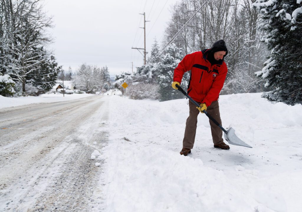 David June jokes as he shovels snow.