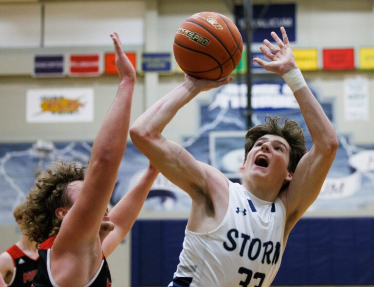 Squalicum’s Kyle Heaton shoots over a defender reaching for the ball.