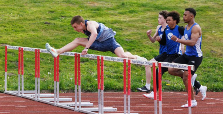 Squalicum’s Andre Korbmacher leaps over the first hurdle en route to breaking the state record.