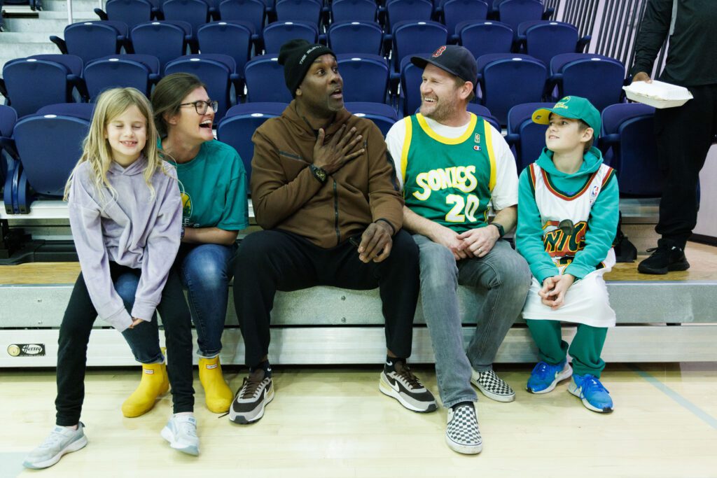 Gary Payton, former Seattle SuperSonics player and current Lincoln University head coach, gets the Larner family laughing as they meet after the game.