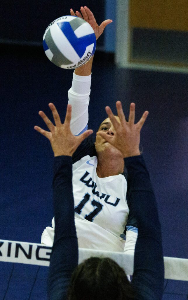 estern Washington University's Tess Biscup spikes the ball over the net and her opponent.