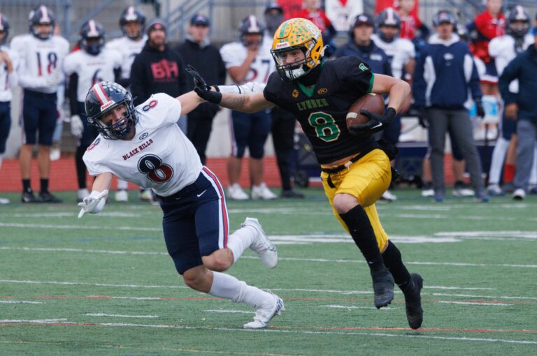 Lynden's Isaiah Stanley catches the ball and tries to dash past a defender.