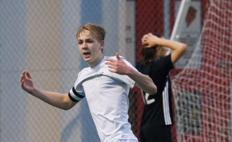 Squalicum’s Xander Koenig celebrates as he gestures with both hands as another player reacts behind him.