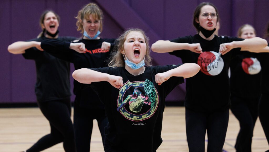 Sara Jackson and her teammates keep fierce facial expressions while practicing for a routine.