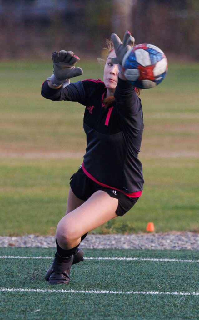 Ferndale goalie Sofia Gardoski gets a hand on the ball as she dives for the ball.