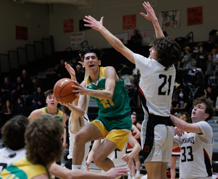 Lynden’s Anthony Canales looks for an opening as Bellingham’s Kincade Vanhouten raises his arms in an attempt to block.