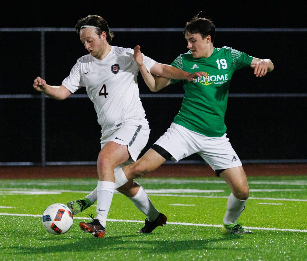 Sehome’s Barrett Cerenzia kicks the ball between the legs of Bellingham's Owen Geis-Poage.