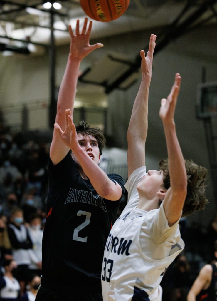 Bellingham's Ian O'Roarty makes a basket over Squalicum's Kyle Heaton.