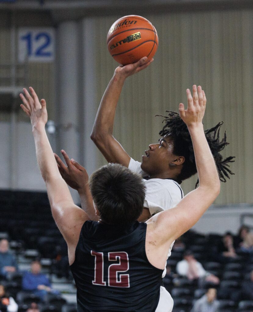 Blaine’s Mathew Russ looks to score as a defender tries to block the shot.