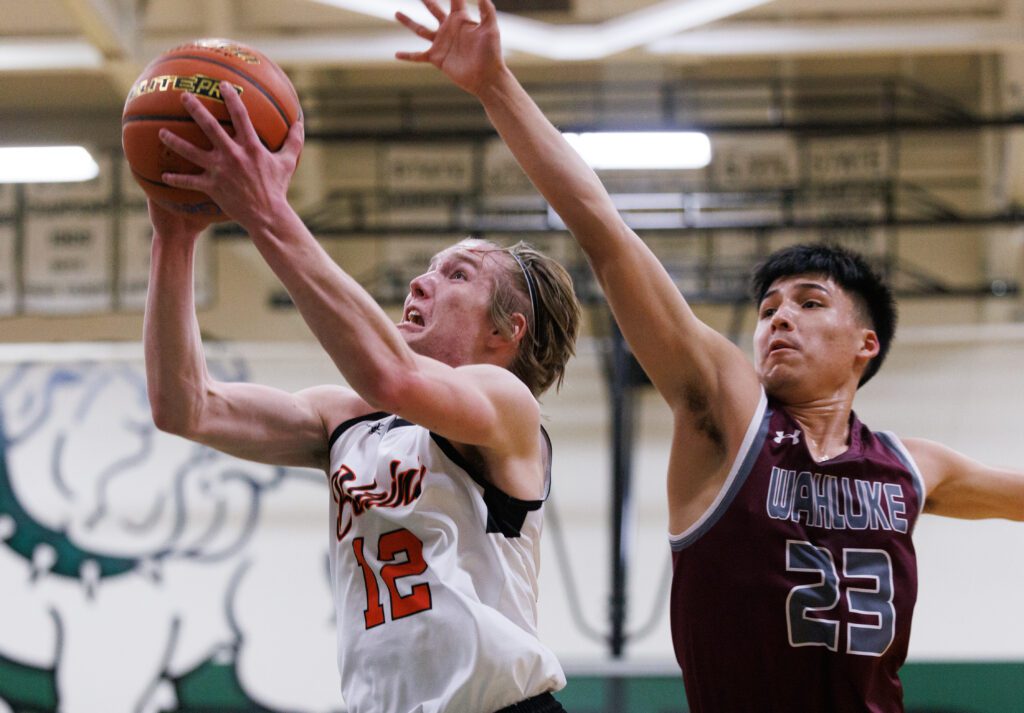 Blaine's Scott Baldwin gets past Wahluke's Orlando Nunez who is reaching for the ball.