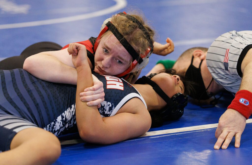 Mount Baker's Tempest Heiner pins Lindbergh’s Purnima Gurung to the bright blue wrestling mat.