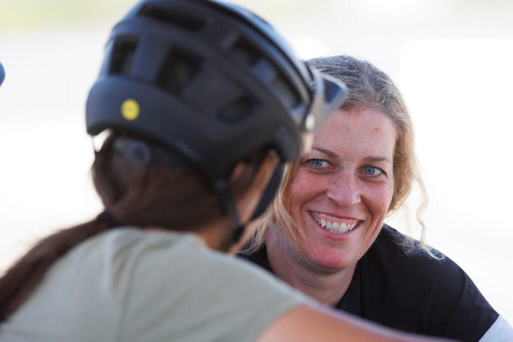 Jill Kintner, right, chats with Matilda Melton who is wearing a bicycle helmet.