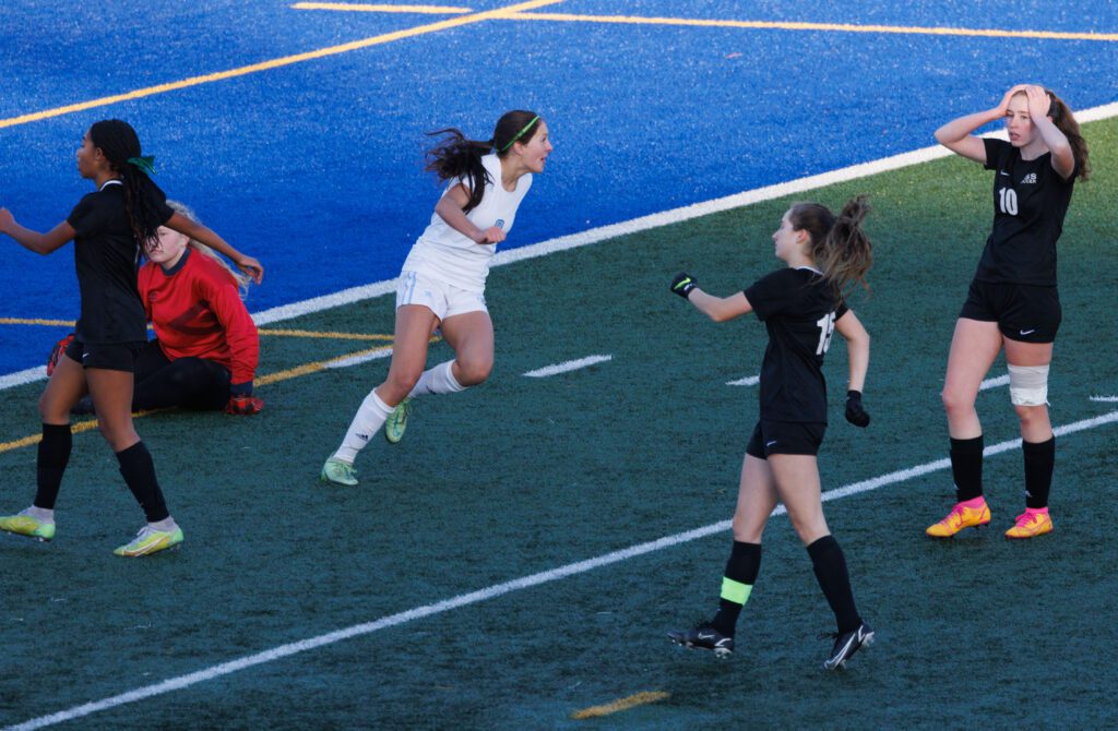 Lynden Christian's Demi Dykstra turns to her teammates as other players react negatively around her.