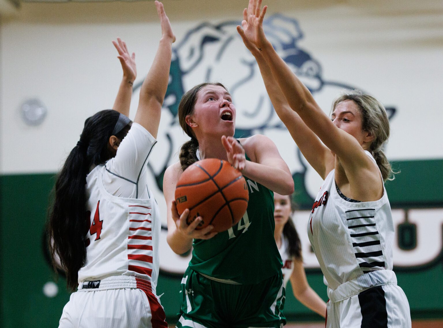Lynden's Haylee Koetje passes through two Archbishop Murphy defenders for a shot at the basket. Koetje’s 14 points were not enough to overcome Archbishop's offense as the Lions lost 43-38 at Mount Vernon High School on Feb. 15.