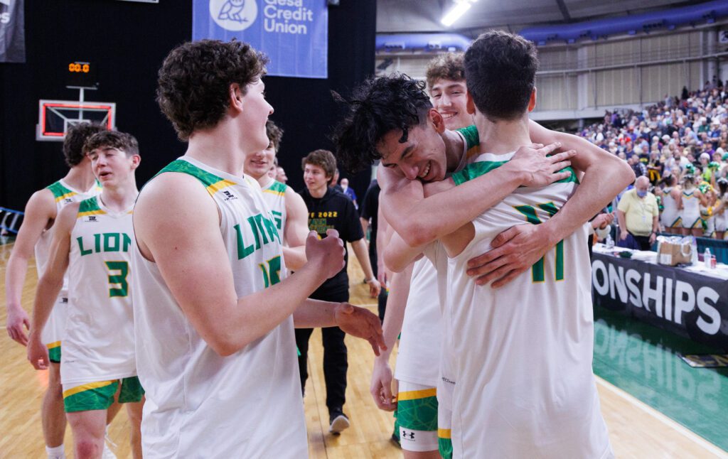 Lynden’s Anthony Canales hugs Jordan Medcalf (11).