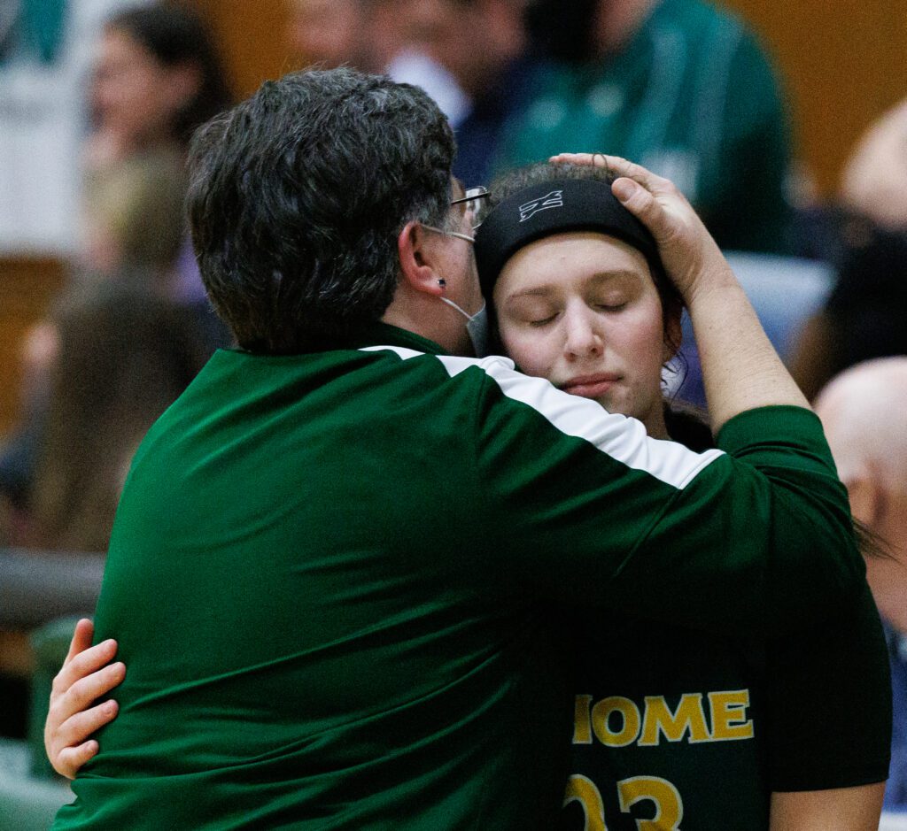 Sehome coach Trish Neary comforts Ava Lunny with a hand on her head.