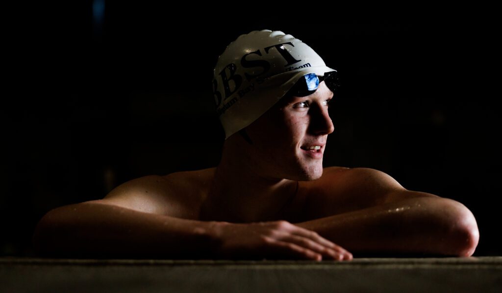 Cratsenberg turns to the side with his swimming cap and goggles on.