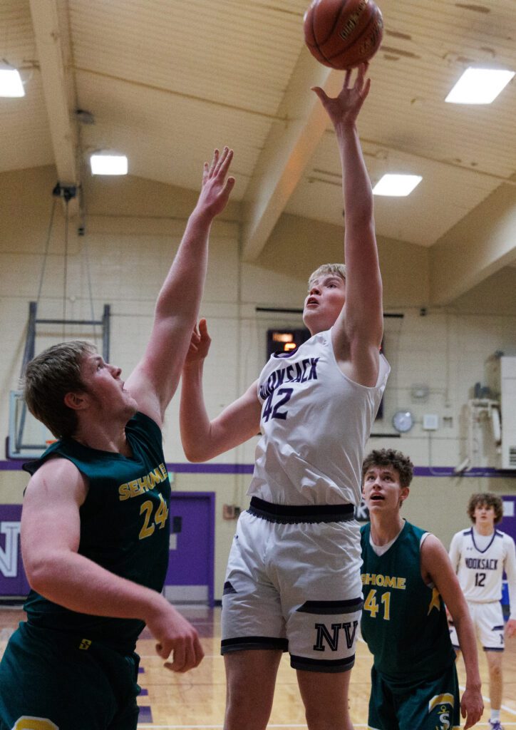 Nooksack Valley's Brady Ackerman sinks a shot over Sehome's Gavin Ortega.