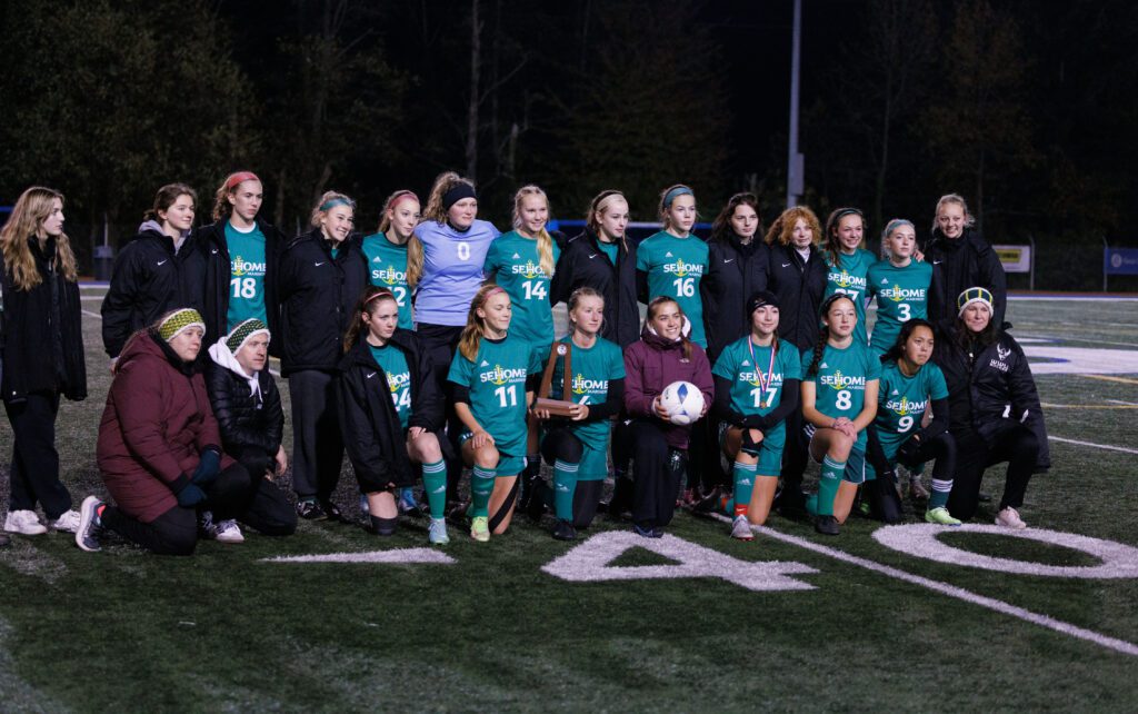 Sehome players pose for a group photo with the second-place trophy.