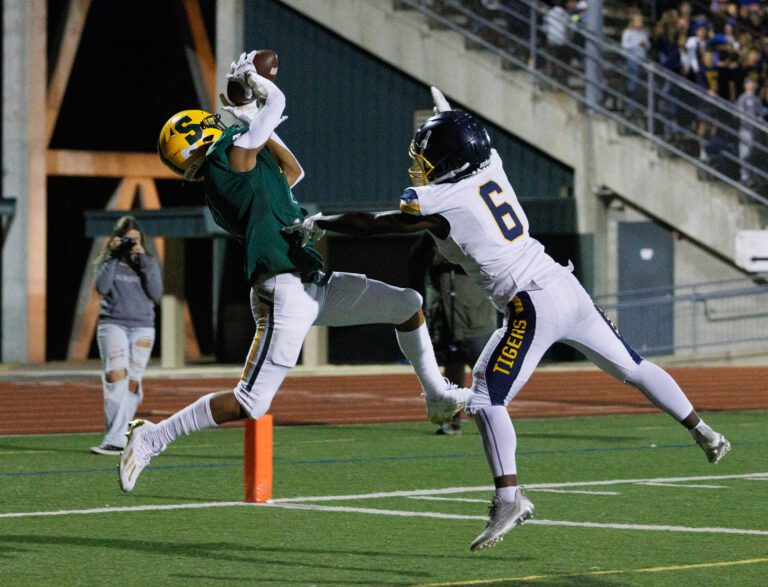 Sehome’s Andre Watson hauls in a touchdown pass as a defender fails to block the pass.