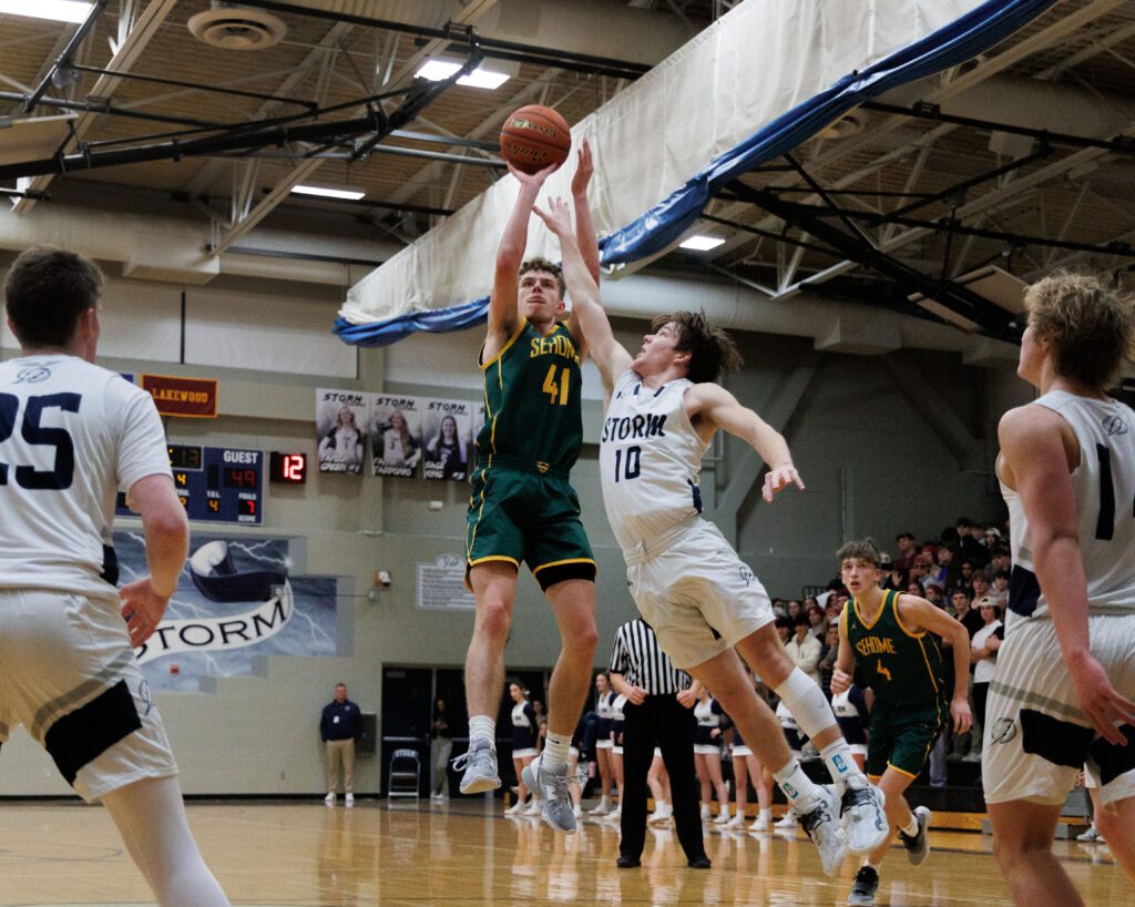 Sehome’s Grant Kepley puts up a shot as a defender leaps to reach for the ball.