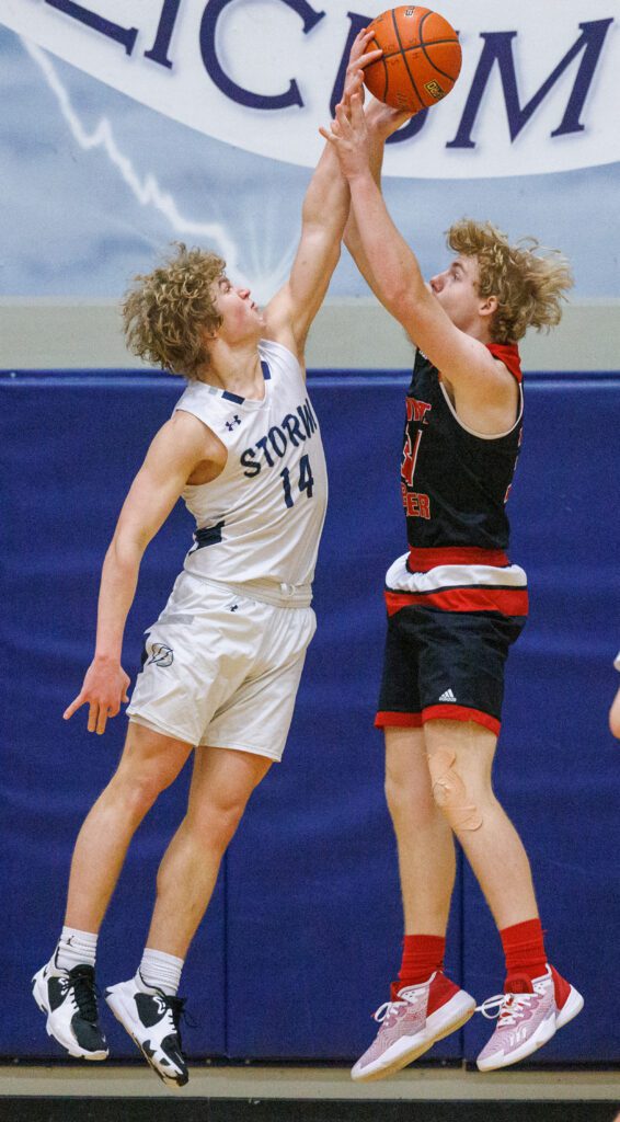 Squalicum’s Nick Watt blocks a shot by Mount Baker's Riley Kruse.