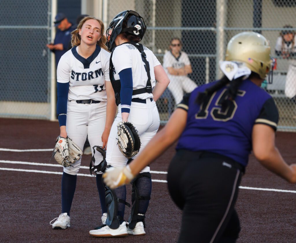 Squalicum's Regan Andersen reacts with her posture dropping as she talks with catcher Liv Paoli.