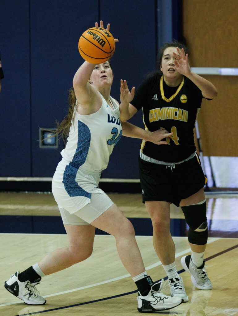 Western Washington University’s Carley Zaragoza steals the ball as she shoves with her free hand.