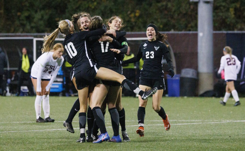 Western Washington University players group hug Sophie Bearden Croft (17) after her first goal.