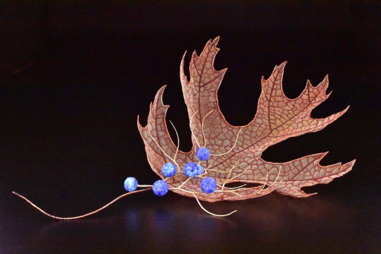 “Enveloping Nature” is one of Lanny Bergner's flame-painted mesh sculptures on display.