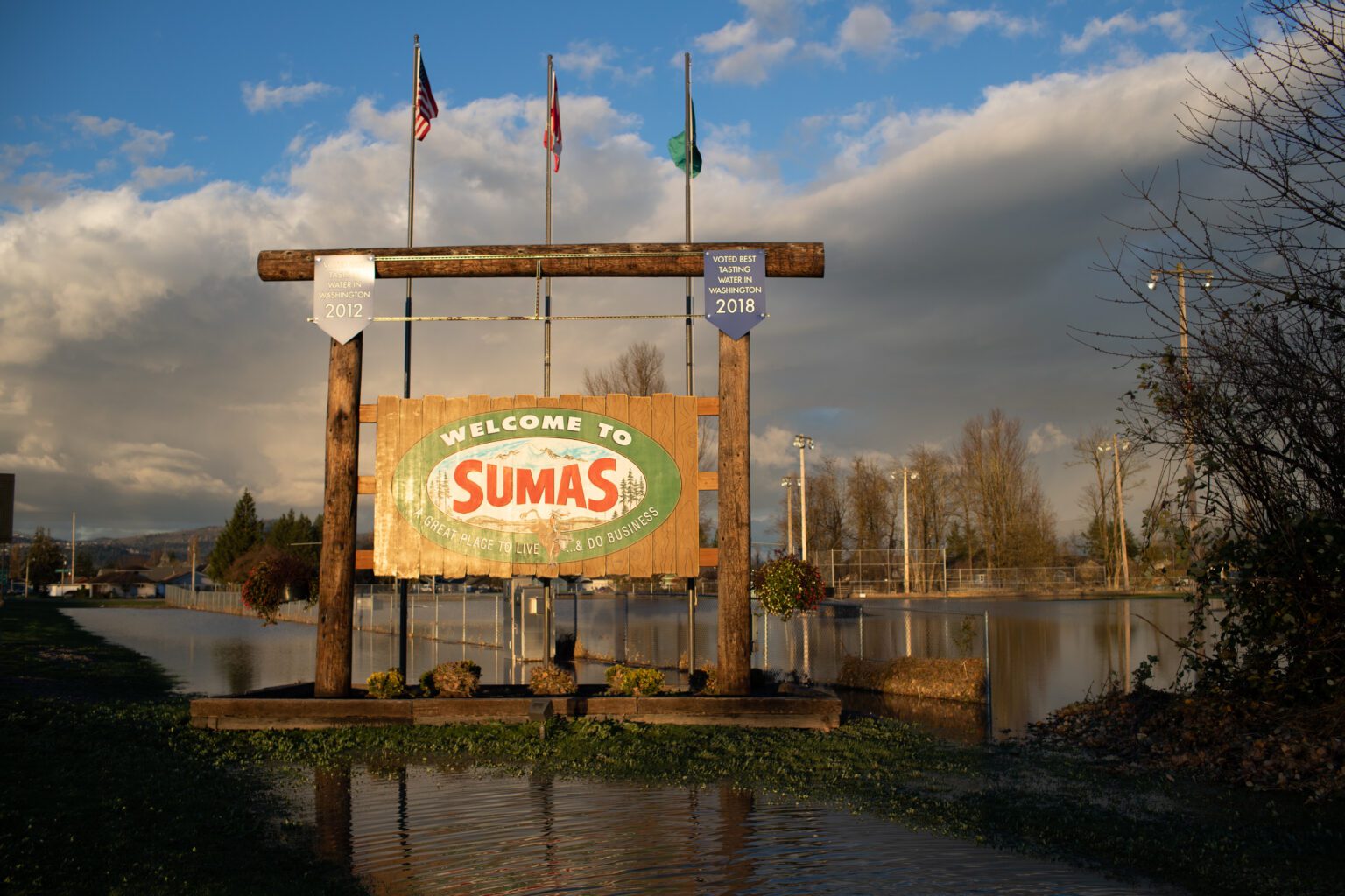 Sumas; large outdoor sign with parts of the logs submerged in the flood.