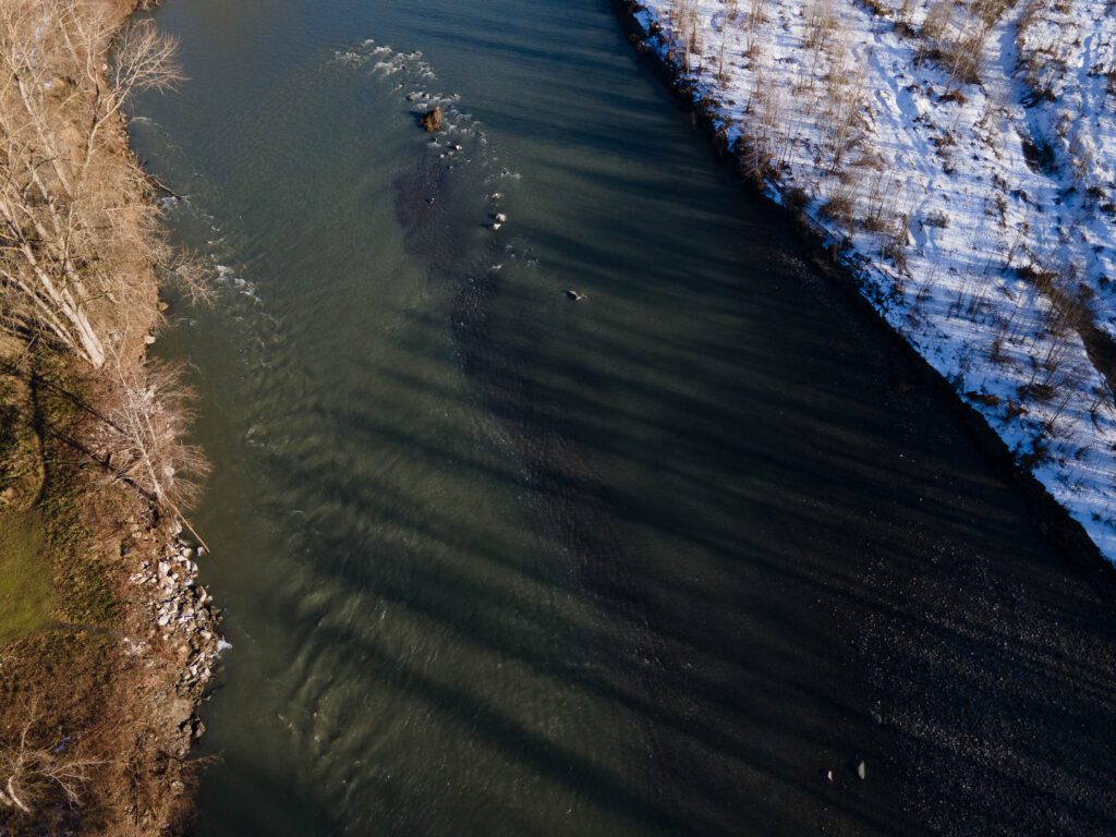 An aerial view of the Nooksack River surrounded by different environments.