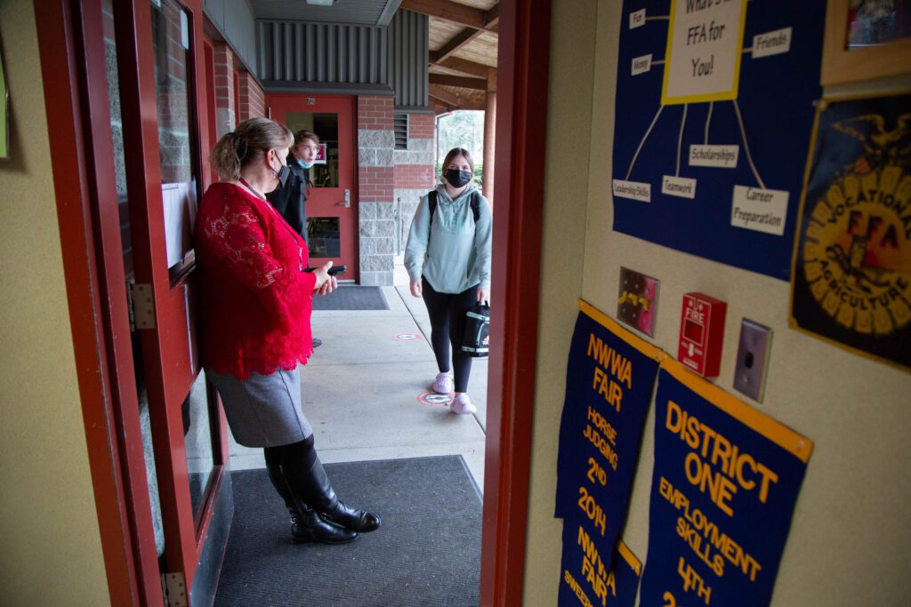 Nicole Kuklenski greets students at the door.