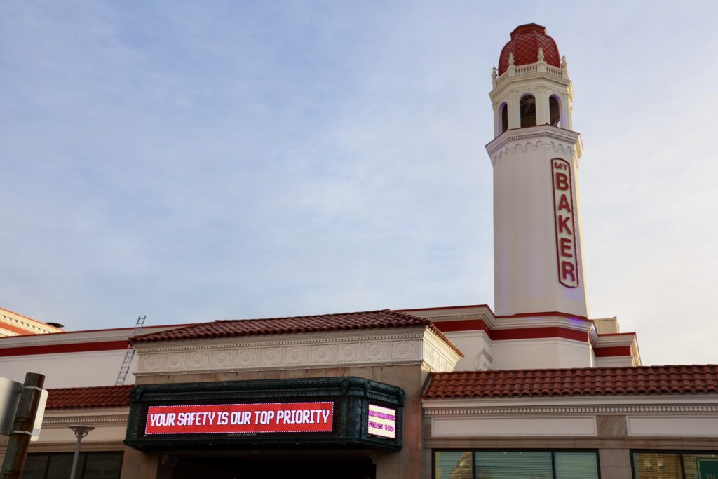 Messages about safety and upcoming shows scroll through Mount Baker Theatre's marquee.