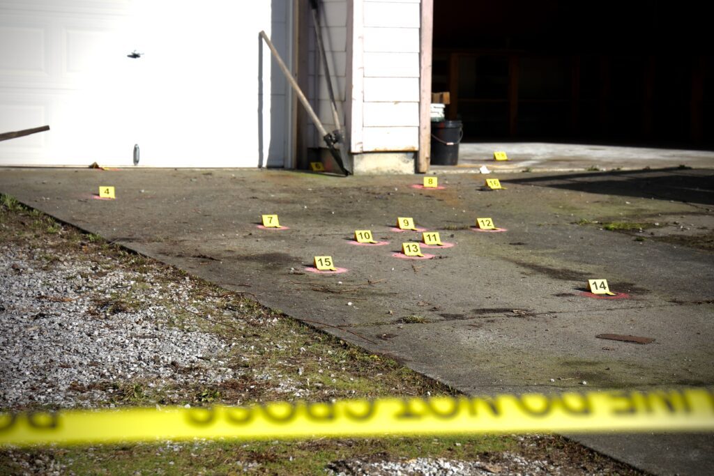 Numbers designate shell casings on the driveway.