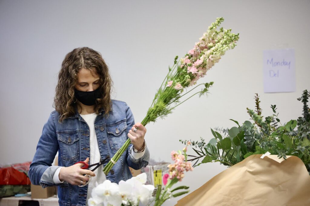 Audrey Burrell carefully cuts each flower stem to a slated point.